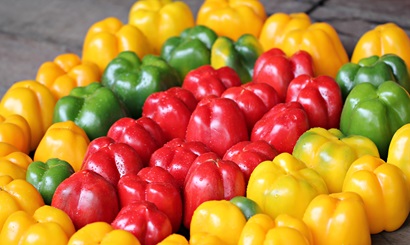 A collection of red, green and yellow capsicums