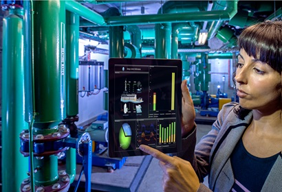 Scientist pointing at ipad screen displaying energy graphs