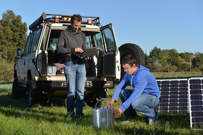 Two scientists and research equipment in a field.