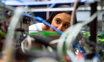Female scientist looks through computing wires