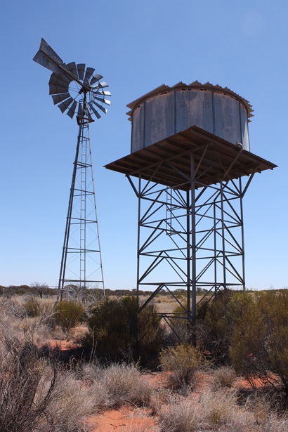 A picture of a windmill and water storage tank located in the Musgrave Province South Australia.