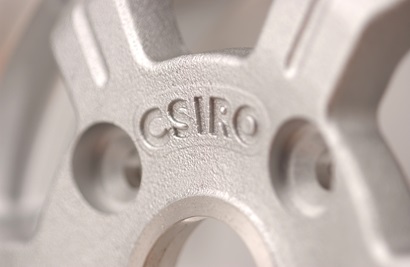 Magnesium alloy casting with CSIRO printed on it.