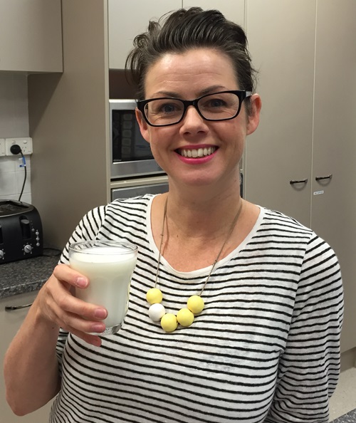 Dr Sinead Golley holds a glass of milk.