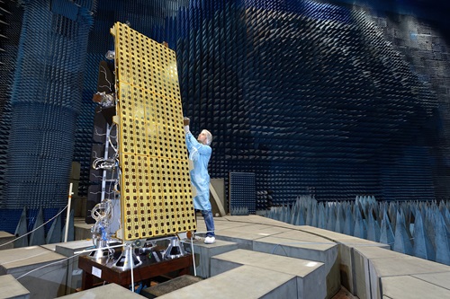 A technician works on the NovaSAR satellite in clean room.