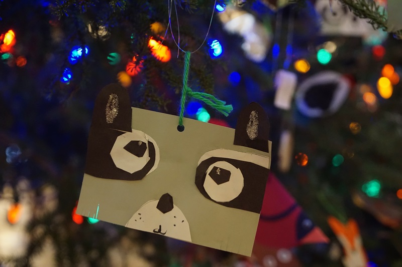 Christmas tree decoration of an animal (racoon) made out of paper.