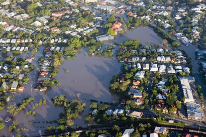Aerial videw of the flooded Brisbane Rivers - houses, roads and green spaces all flooded.