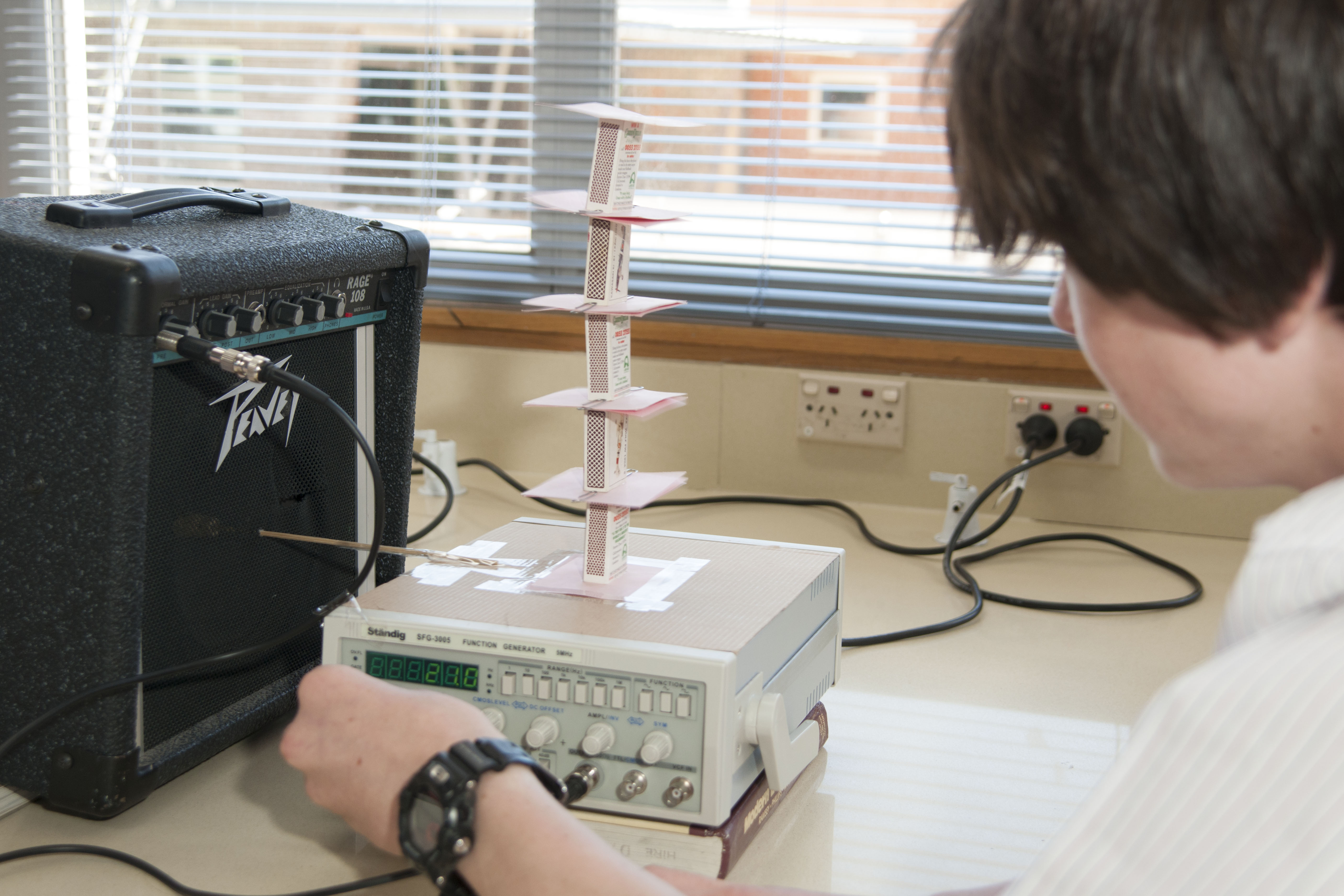 A student looks closely at his experiment 