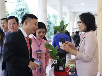 A man and woman in Vietnam talking to each other at an innovation fair