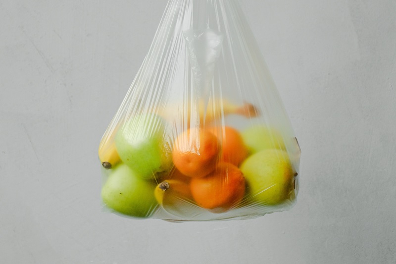 A plastic bag holding fruit
