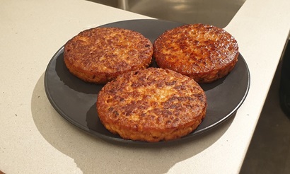 A cooked v2food burger patty.