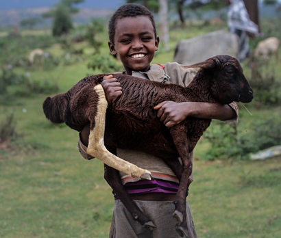 Child with goat in Sub Saharan Africa.