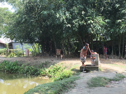 Ladies at a water well in rural setting