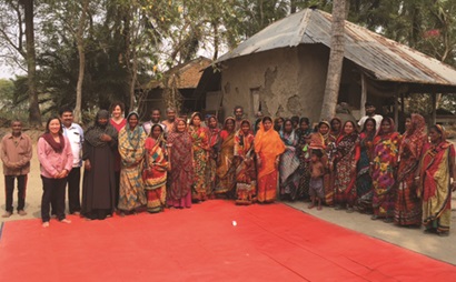 Villagers from Dacope, Bangladesh, who are participating in the SIAGI project, pose for a photo outside one of their houses