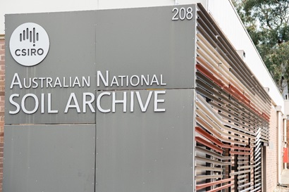 Partial view of the outside of the Australian National Soil Archive building displaying the sign in large white lettering and the CSIRO logo. 