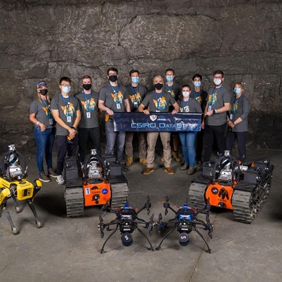 The accompanhying image includes a group photo of the Team CSIRO Data 61 DARPA team and the image has overlay text in the foreground. The people in the image are standing together in an underground setting and are all wearing masks. There are 11 team members in the image and they are all wearing grey team shirts. In front of them on the ground is a range of their robots that they used in the challenge. In the foreground, there re two blocks of text. The first block of text says: The Chair's Medal for Science and Engineering Excellence. The second block of text says: Congratulations to the Team CSIRO DARPA SubT Challenge. Properties Others Goal Awareness Content Type Owned Campaign Proactive Nov 14, 2019 - ∞ 10.9K 0 Collaboration T TW Super User • 5:13 PM, 7 Dec 2022 Amy Tindale Attachments No Attachments added yet. Description The accompanhying image includes a group photo of the Team CSIRO Data 61 DARPA team and the image has overlay text in the foreground. The people in the image are standing together in an underground setting and are all wearing masks. There are 11 team members in the image and they are all wearing grey team shirts. In front of them on the ground is a range of their robots that they used in the challenge.
