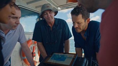This image is a photo of the Reef Intelligence Team reviewing data with their Industry Partner (Google). The photo includes 3 people in focus and two put of focus people to the side. The text included on this image is: The CSIRO Collaboration Medal Congratulations to the Reef Intelligence Team Properties Others Goal Awareness Content Type Owned Campaign Proactive Nov 14, 2019 - ∞ 10.9K 0 Collaboration T TW Super User • 4:41 PM, 7 Dec 2022 Amy Tindale Attachments No Attachments added yet. Description This image is a photo of the Reef Intelligence Team reviewing data with their Industry Partner (Google). The photo includes 3 people in focus and two put of focus people to the side.