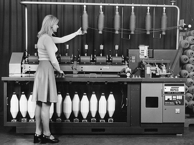 Woman standing in front of CSIRO's patented Repco self-twist spinning machine