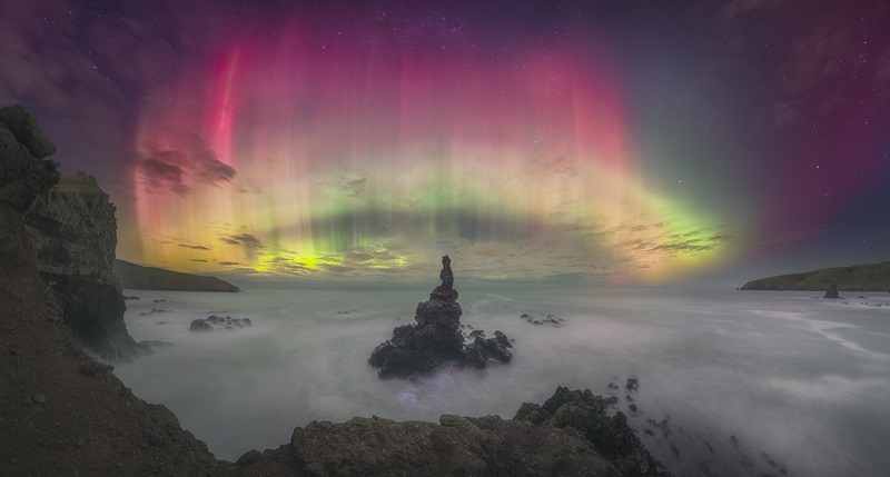 Aurora of light above a seascape