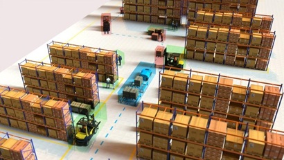 The image shows a birds-eye view of a warehouse stacked with boxes. Machinery and people are shown on the warehouse floor with a coloured box overlay and path lines on the ground.
