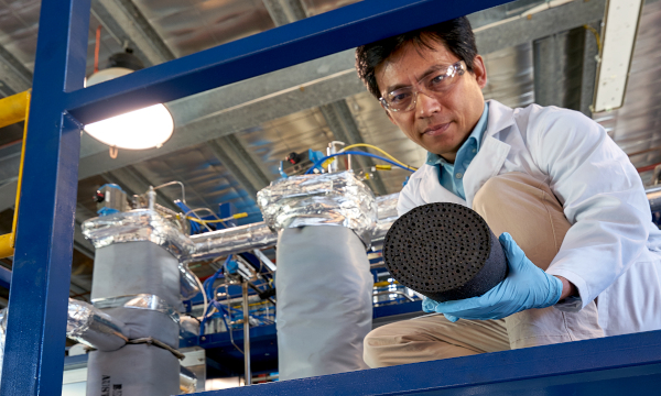 Image of researcher with coal in a laboratory.