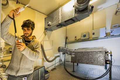 A man holding up some scientific equipment