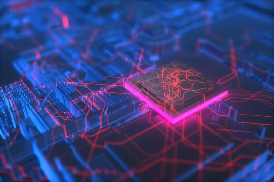 Glowing computer chip in a circut board showing red lines extending out across the various components on the board. 