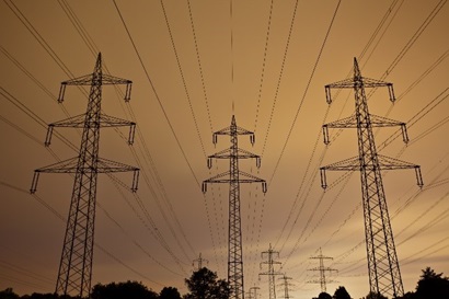 Power lines againstt an orange sky