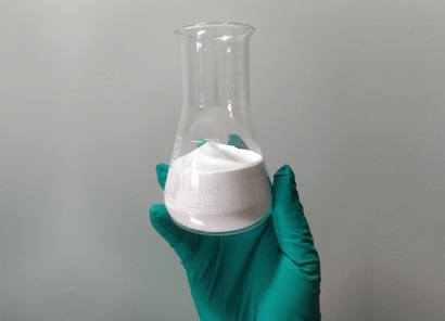 Glass beaker with white chemical substance