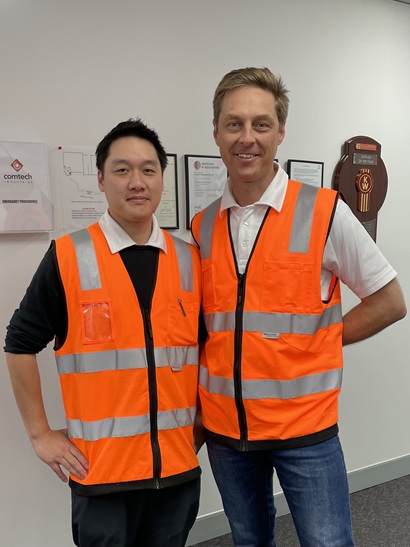 Two men smiling at camera
