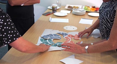 Small pieces of paper making up a jigsaw puzzle