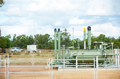 Coal seam gas plant with trees in the background. 