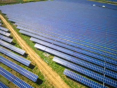 Large solar farm on either side of a road.