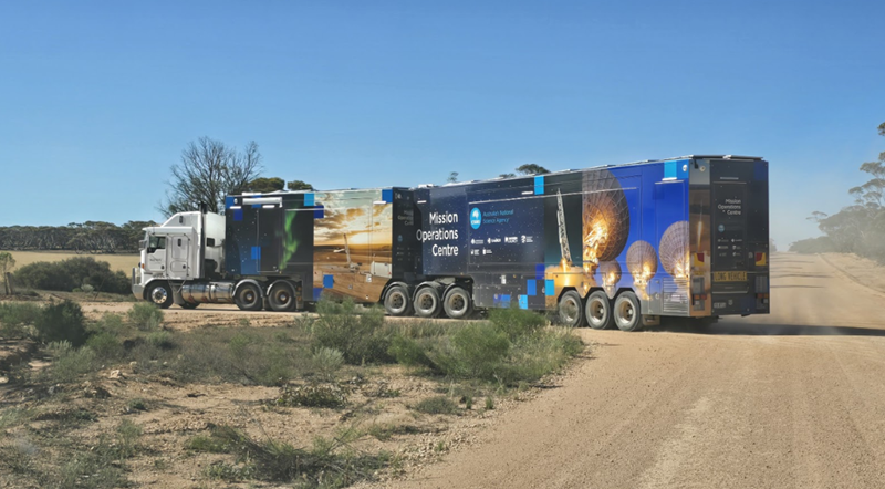 CSIRO's Mobile Mission Operations Centre truck on a dirt road surrounded by rural landscape and open sky.