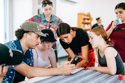 Students and camp leaders use iNaturalist to identify plants found on their bushwalk, contributing to citizen science while connecting with Country through sensory exploration and teamwork.