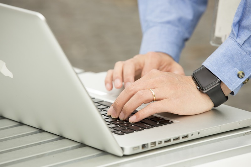 Person typing on a laptop keyboard