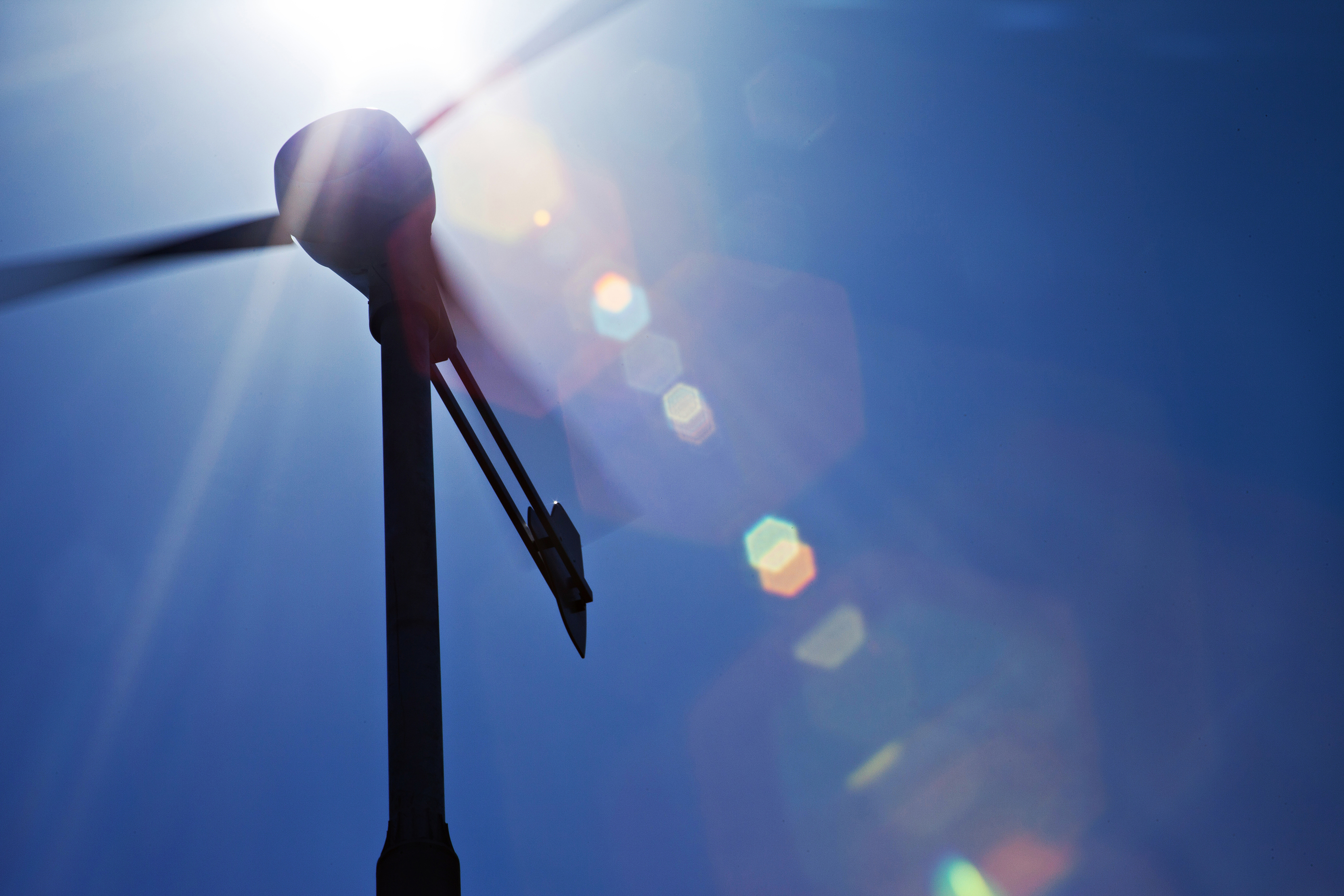 Wind turbine silhouetted against the sun at the CSIRO Energy Centre, Newcastle, NSW.