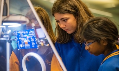 Female students investigate CSIRO's SmartBin prototype