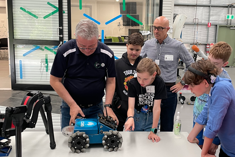 CSIRO staff assist students with a robot