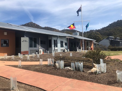 Birrigai Outdoor School building with Australian Aboriginal flag, Australian flag and Torres Strait Islander flag flying out the front. 