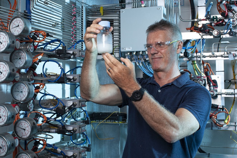 Man inspecting a container in a research faciility.