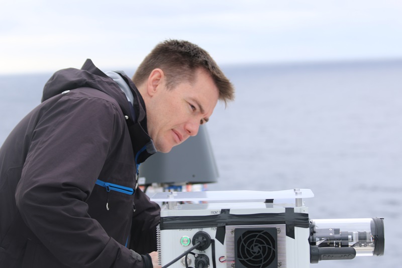 Scientist looks at equipment on board RV investigator
