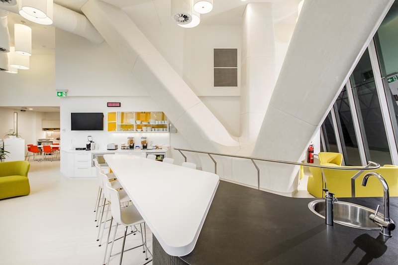 The kitchen at the clinic is modern and bright and includes a breakfast bar, cereal dispensers, couches and a sink.