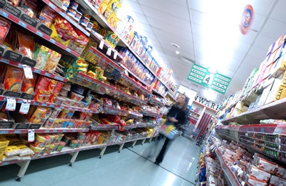 A woman shops in a aupermarket aisle