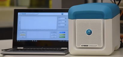 Cybertongue unit next to a laptop on a bench