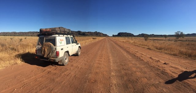 Image of 4-wheel drive vehicle driving on a dirt road in Northern Australia