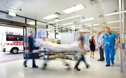 Blurred image of people moving quickly around a hospital.