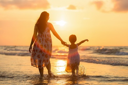 Adult and child on beach