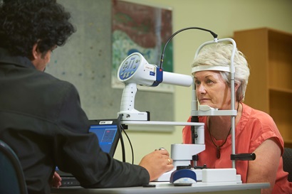 An image of an older woman undertaking an eye screen.
