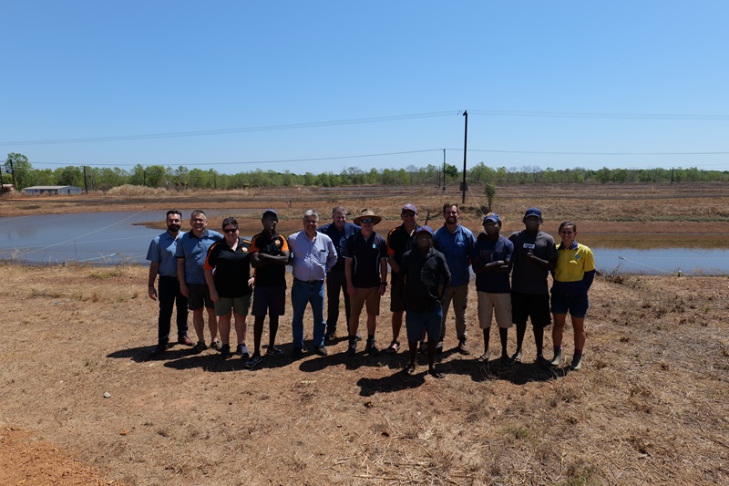 Group of people from CSIRO and the Tiwi Islands standing in front of a prawn farm.