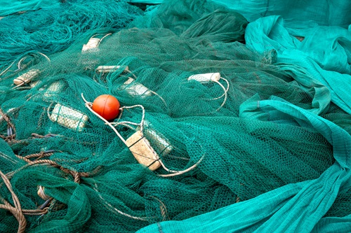 Image of fishing net with plastic and pollution entangled in net